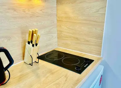 a kitchen with a stove and a knife block at Port Twins Suites No2 in Piraeus