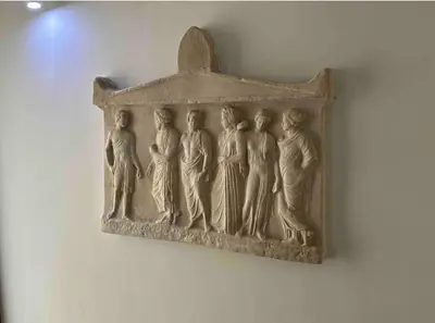a relief of people hanging on a wall at Port Twins Suites No2 in Piraeus