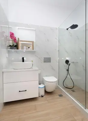 a bathroom with a toilet and a sink and a shower at Niko's Beach Suites Νο2 in Agia Marina Aegina