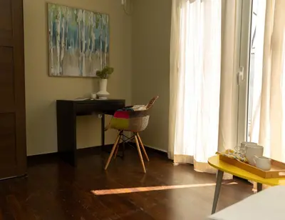 a room with a desk and a chair and a table at Parthenon View Apartment in Athens