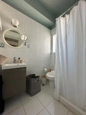 a bathroom with a white shower curtain and a toilet at Parthenon View Apartment in Athens