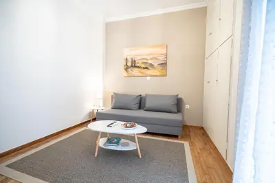 a living room with a couch and a table at kato patisia cozy apartment for 2 persons by MPS in Athens