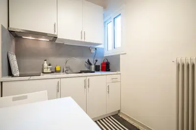 a kitchen with white cabinets and a sink at kato patisia cozy apartment for 2 persons by MPS in Athens