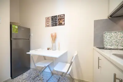 a small kitchen with a white table and chairs at kato patisia cozy apartment for 2 persons by MPS in Athens