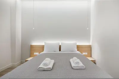 a bedroom with a bed with two towels on it at Porto Pireo by SuperHost365 Leosthenous in Piraeus