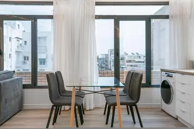 a dining room with a glass table and chairs at Porto Pireo by SuperHost365 Leosthenous in Piraeus