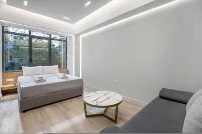 a living room with a couch and a table at Porto Pireo by SuperHost365 Leosthenous in Piraeus