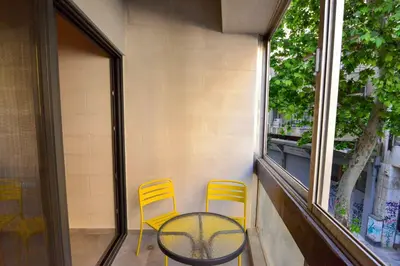 two yellow chairs and a table on a balcony at Athens loft 5 min from Monastiraki metro stop in Athens