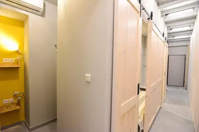 a hallway with a wooden door in a room at Athens loft 5 min from Monastiraki metro stop in Athens