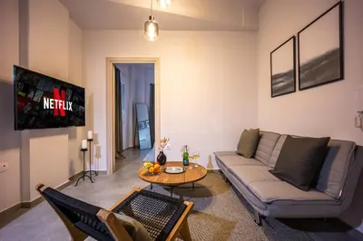 a living room with a couch and a table at City Center Suite in Athens