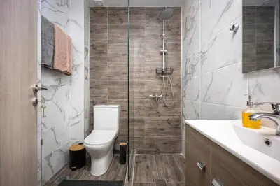 a bathroom with a shower with a toilet and a sink at City Center Suite in Athens