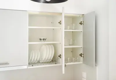 a white cupboard with dishes in it at City Center Suite in Athens