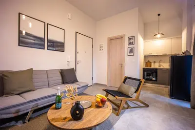 a living room with a couch and a table at City Center Suite in Athens
