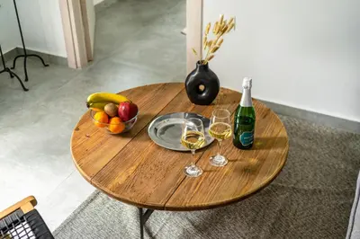 a table with two glasses of wine and a bowl of fruit at City Center Suite in Athens