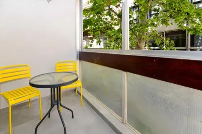 a table and two chairs sitting next to a window at Athens industrial design apt 5 min from Metro in Athens