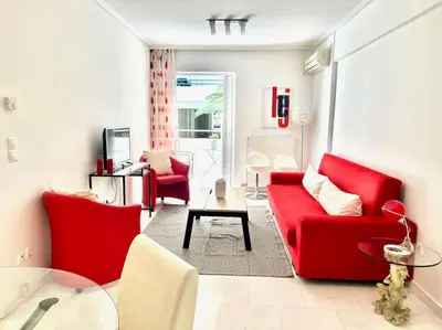 a living room with red chairs and a red couch at Pratinou 1B/R apartment in Athens