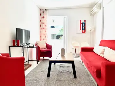 a living room with a red couch and red chairs at Pratinou 1B/R apartment in Athens