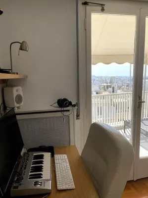 a desk with a keyboard and a computer on a table at Beautiful 94 sq.m apartment with view over Athens in Athens