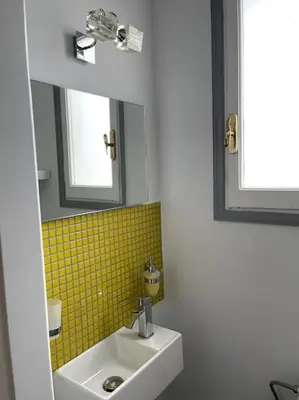 a bathroom with a sink and a mirror at Beautiful 94 sq.m apartment with view over Athens in Athens