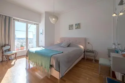 a bedroom with a large bed and a window at Beautiful 94 sq.m apartment with view over Athens in Athens