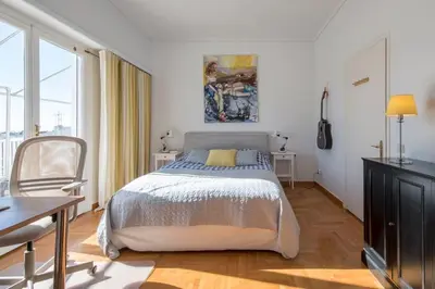 a bedroom with a bed and a table and a chair at Beautiful 94 sq.m apartment with view over Athens in Athens