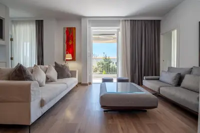 a living room with a couch and a coffee table at Athens Riviera Aelia Luxury Suite By The Sea in Athens
