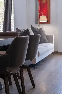 a living room with a couch and a table and chairs at Athens Riviera Aelia Luxury Suite By The Sea in Athens