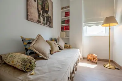a room with a bed with pillows and a lamp at Athens Riviera Aelia Luxury Suite By The Sea in Athens