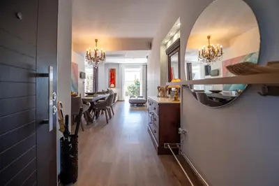 a kitchen and dining room with a mirror on the wall at Athens Riviera Aelia Luxury Suite By The Sea in Athens