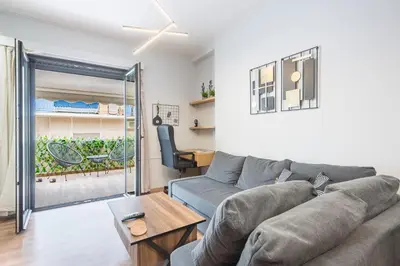 a living room with a couch and a table at Newly Renovated Loft 1 min walk from metro by Cloudkeys in Athens