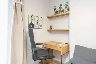 a bedroom with a desk and a chair next to a table at Newly Renovated Loft 1 min walk from metro by Cloudkeys in Athens