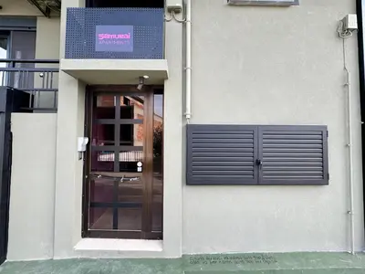 a building with a door and a sign on it at Samurai apartments -Catrin- in Koropíon