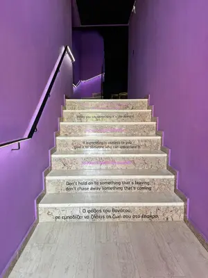 a staircase with a poem on the side of a purple wall at Samurai apartments -Catrin- in Koropíon