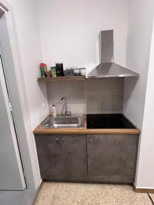 a small kitchen with a sink and a stove at 2BDR q in Athens