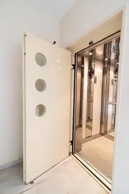 a sliding glass door with three lights on it at Maria's Airport Apartment, 4' metro, 10' airport, 15' beach, 40' city center in Koropíon