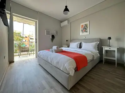 a bedroom with a large bed with a red blanket at D150 Orange & New Life - Cloud9 in the city in Athens