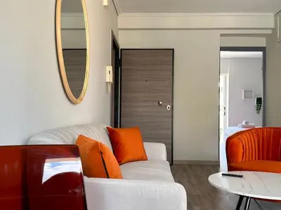 a living room with a white couch and a mirror at D150 Orange & New Life - Cloud9 in the city in Athens