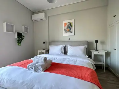 a bedroom with a large white bed with towels on it at D150 Orange & New Life - Cloud9 in the city in Athens