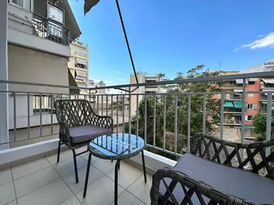 a balcony with chairs and a table on a building at D150 Orange & New Life - Cloud9 in the city in Athens