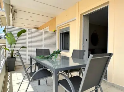 a table and chairs on a balcony with a table and chairsktop at D150 Orange & New Life - Cloud9 in the city in Athens