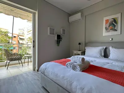 a bedroom with a large white bed with a red blanket at D150 Orange & New Life - Cloud9 in the city in Athens