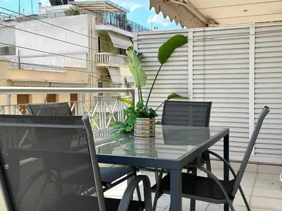 a table and chairs on a balcony with a plant at D150 Orange & New Life - Cloud9 in the city in Athens