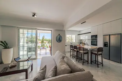 a living room with a couch and a table at Lagonisi Luxury Escape in Lagonissi