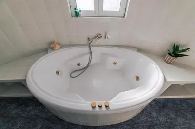 a large white bath tub in a bathroom at Lagonisi Luxury Escape in Lagonissi