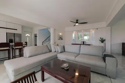 a living room with a couch and a table at Lagonisi Luxury Escape in Lagonissi