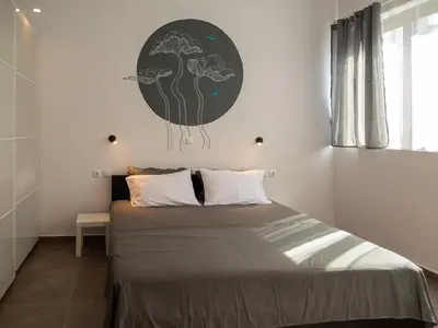 a bedroom with a bed with a black and white poster on the wall at Prasa in Piraeus
