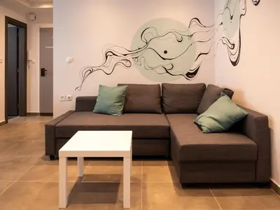 a living room with a couch and a table at Prasa in Piraeus