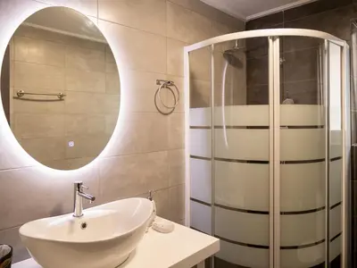 a bathroom with a sink and a mirror at Prasa in Piraeus