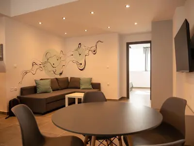 a living room with a couch and a table at Prasa in Piraeus
