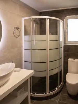 a bathroom with a shower and a toilet and a sink at Prasa in Piraeus